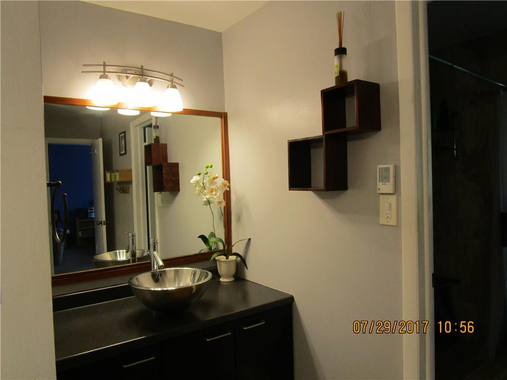 9711 North New River Canal Road, Unit 212 Plantation, FL 33324 - Photo 24 of 41 a bathroom with a sink and a mirror