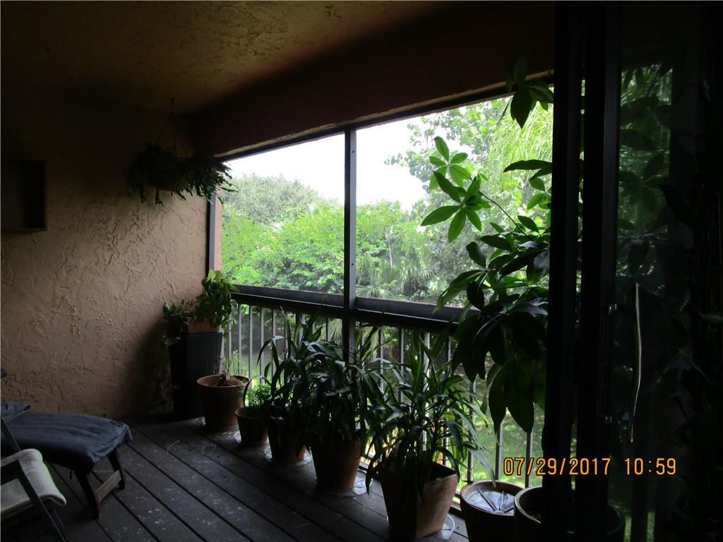 9711 North New River Canal Road, Unit 212 Plantation, FL 33324 - Photo 28 of 41 a view of a balcony with chairs and a potted plant