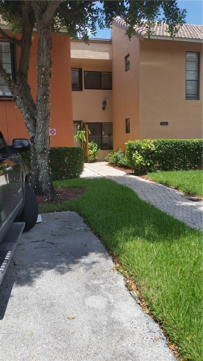 9711 North New River Canal Road, Unit 212 Plantation, FL 33324 - Photo 3 of 41 a front view of a house with garden
