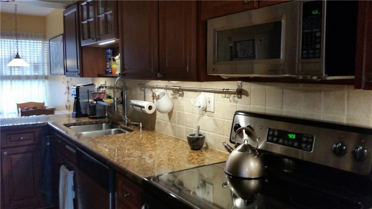 9711 North New River Canal Road, Unit 212 Plantation, FL 33324 - Photo 7 of 41 a kitchen with a sink appliances and cabinets
