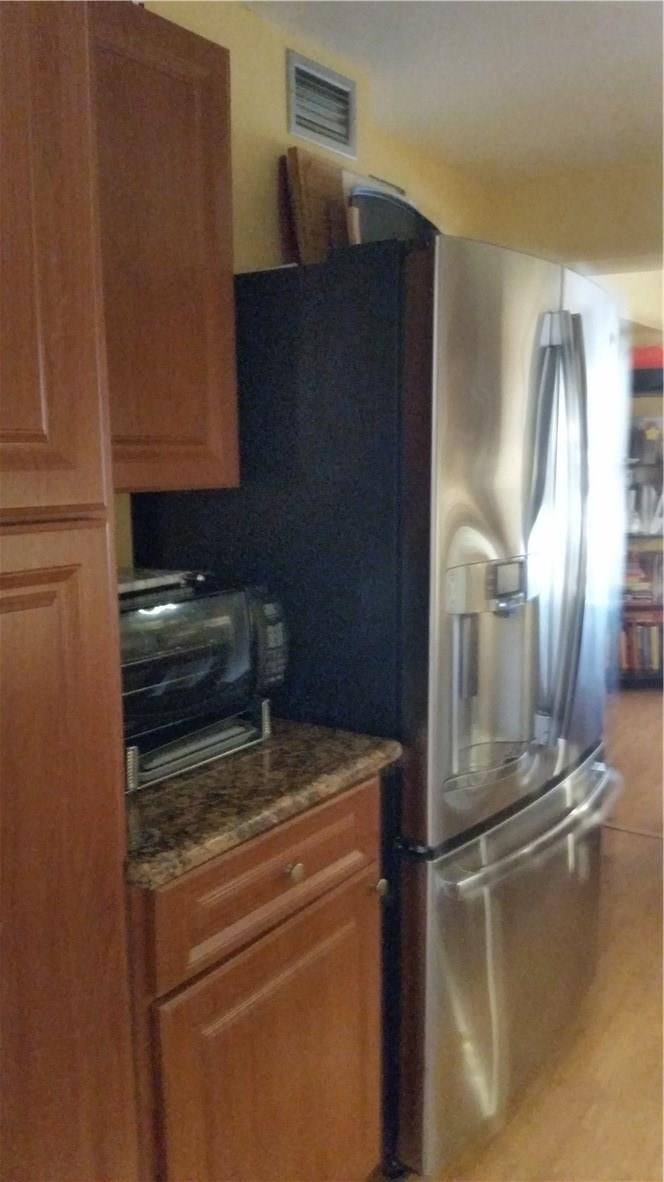 9711 North New River Canal Road, Unit 212 Plantation, FL 33324 - Photo 8 of 41 a close view of water heater and stove in a kitchen