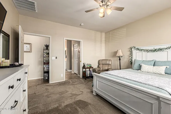 a bedroom with a bed and a chandelier