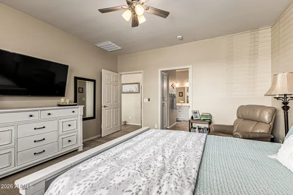 a bedroom with furniture and a flat screen tv