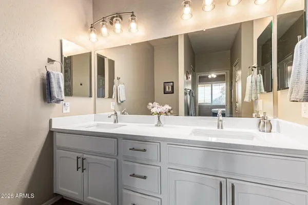 a bathroom with a double vanity sink and a mirror