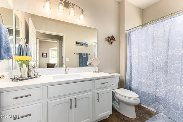 a bathroom with a toilet a sink and a mirror