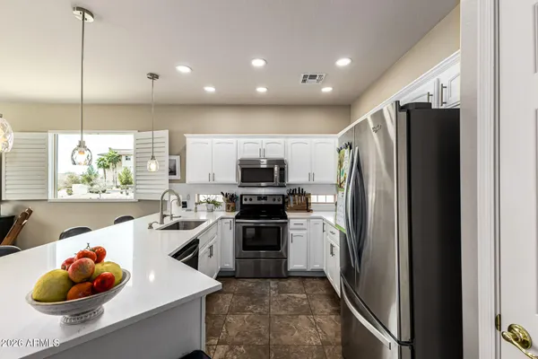 a kitchen with stainless steel appliances a refrigerator sink and stove