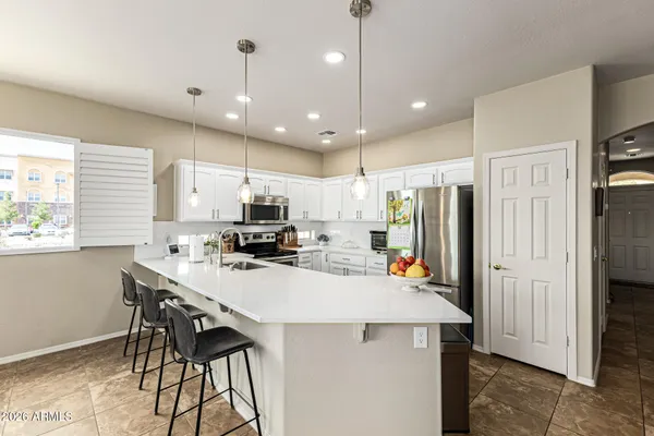a kitchen with a sink a refrigerator and a stove top oven