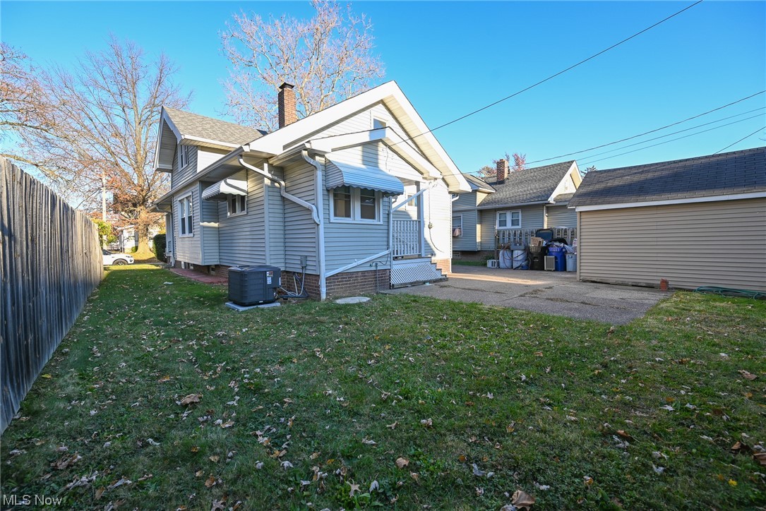 3832 Silsby Road Cleveland, OH 44111 - Photo 3 of 21 Rear view of house with a lawn and central air condition unit