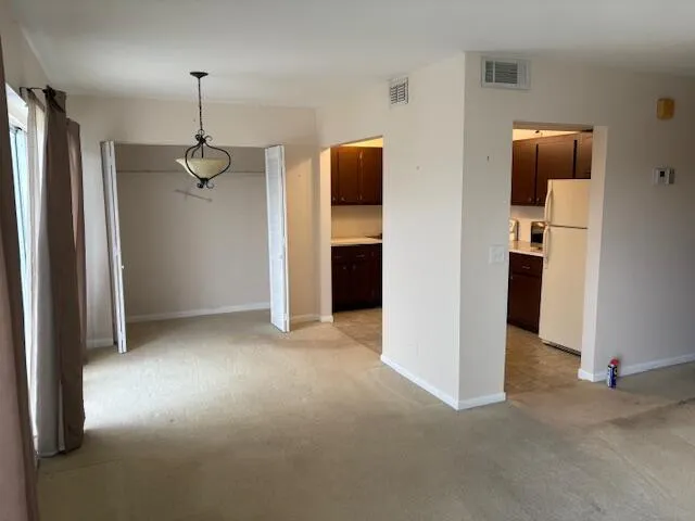 a view of a room has a flat screen tv