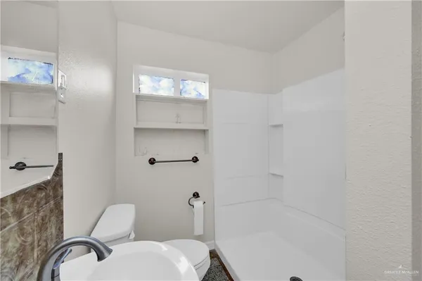 a bathroom with a granite countertop toilet a sink and bathtub