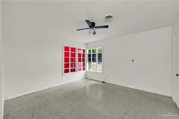 a view of a livingroom with a ceiling fan and window