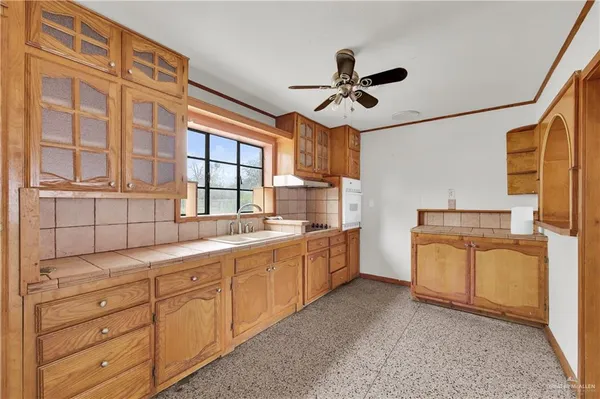a kitchen with sink cabinets and appliances