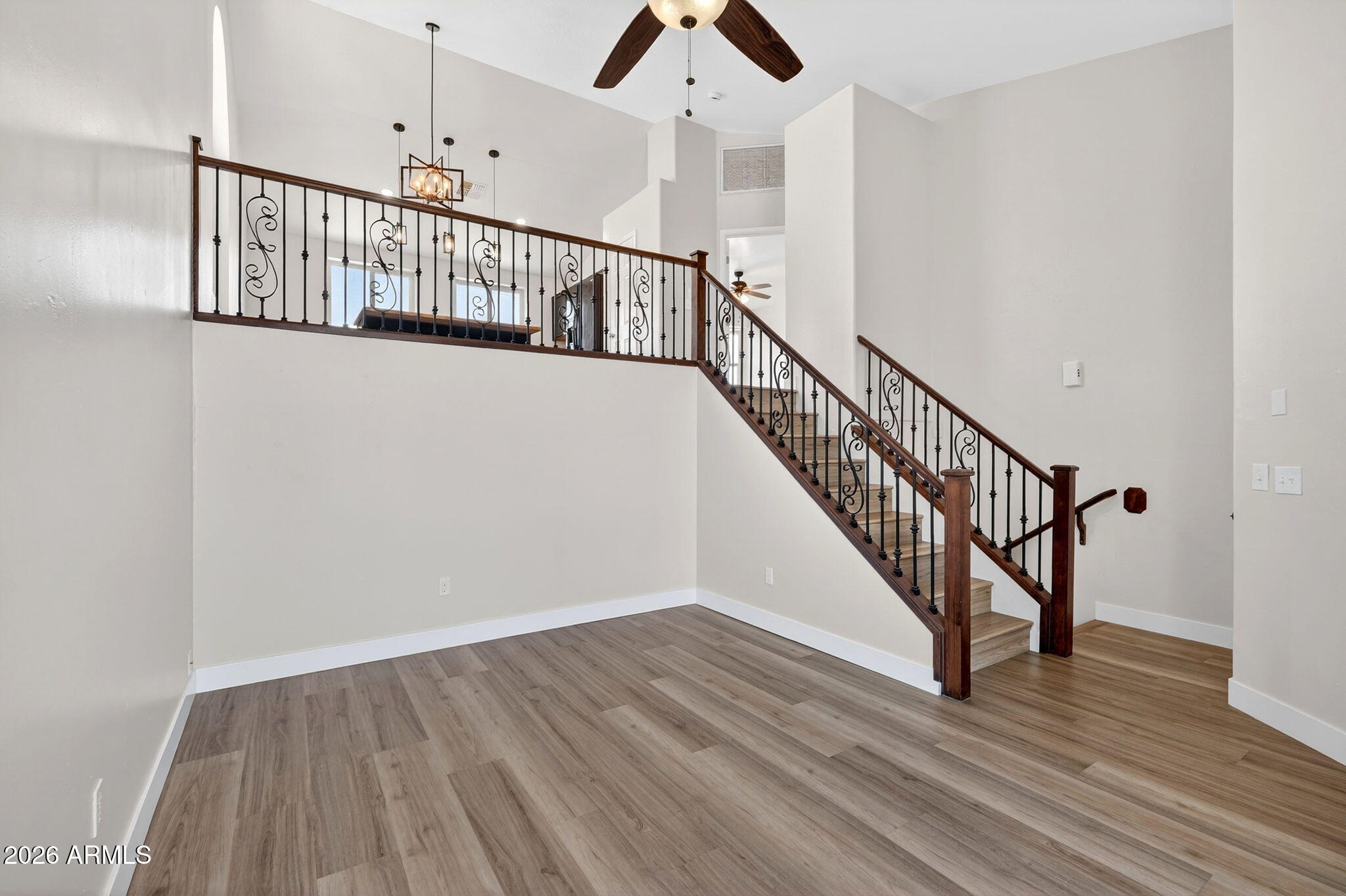 1417 East Mineral Road Gilbert, AZ 85234 - Photo 2 of 59 a view of staircase with wooden floor and white walls