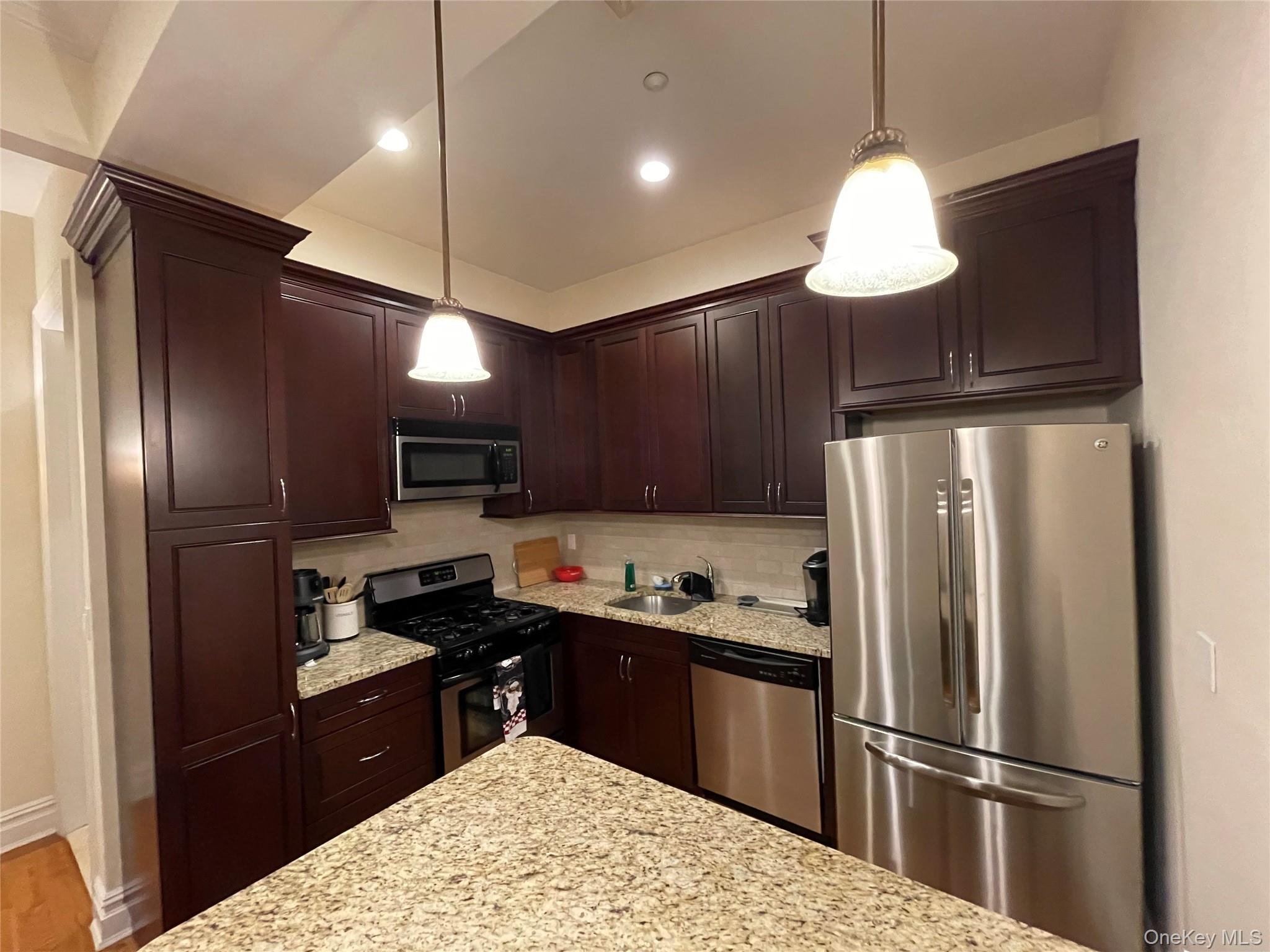 377 New York Avenue, Unit C Huntington, NY 11743 - Photo 8 of 10 a kitchen with stainless steel appliances granite countertop a refrigerator a sink dishwasher a stove and a refrigerator
