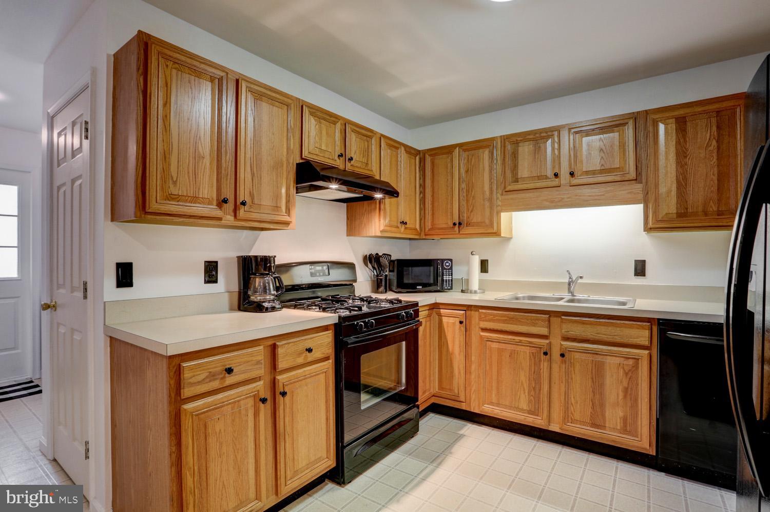 358 Crosswinds Drive Lititz, PA 17543 - Photo 18 of 39 a kitchen with stainless steel appliances granite countertop a sink stove and refrigerator