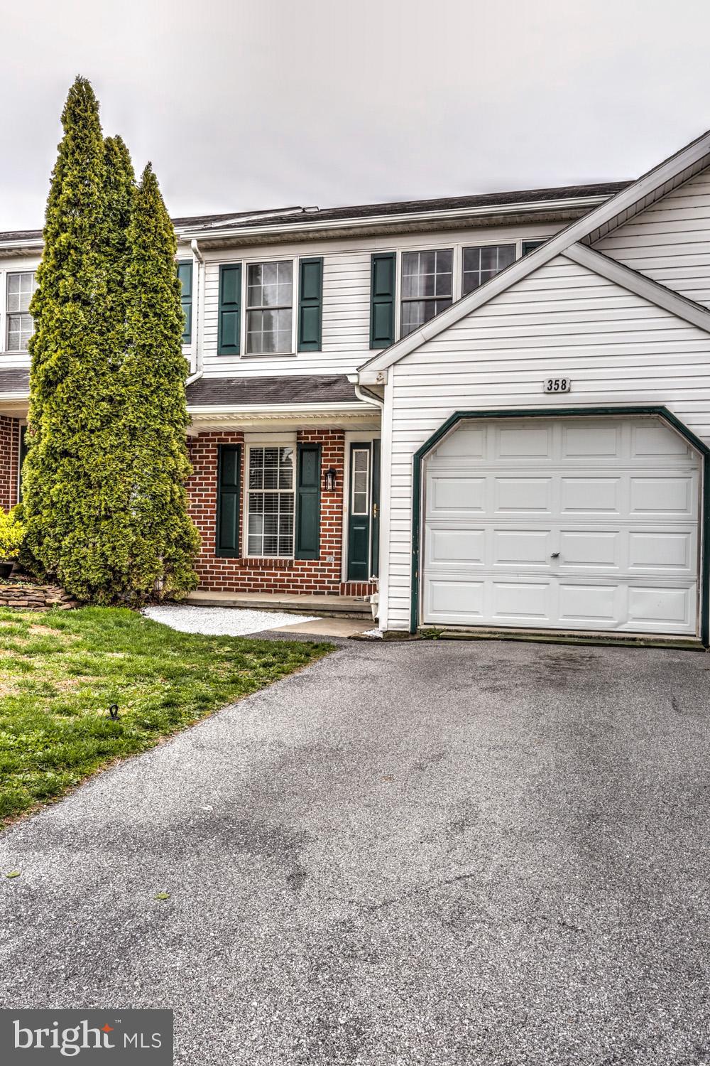 358 Crosswinds Drive Lititz, PA 17543 - Photo 3 of 39 a front view of a house with a garden and garage