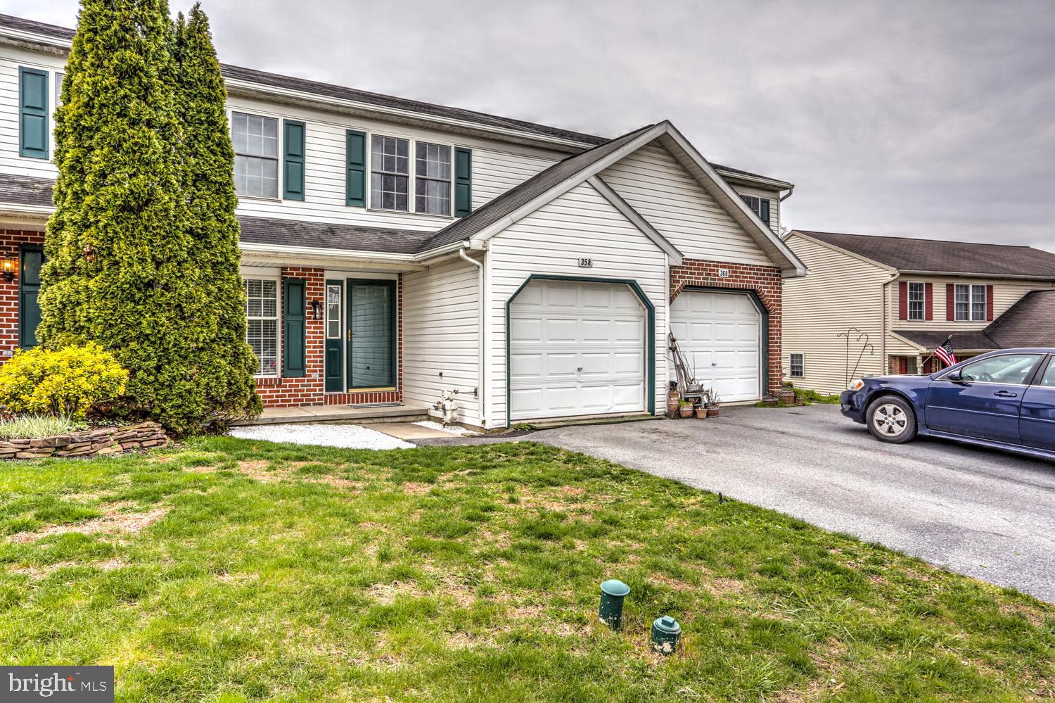 358 Crosswinds Drive Lititz, PA 17543 - Photo 4 of 39 a front view of a house with a yard and garage