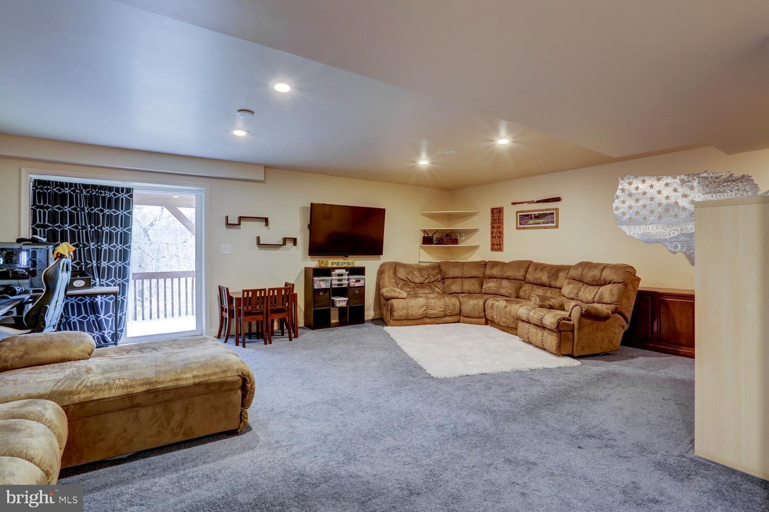 358 Crosswinds Drive Lititz, PA 17543 - Photo 36 of 39 a living room with furniture and a flat screen tv