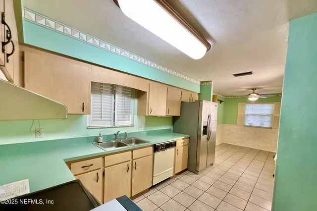 a kitchen with a sink cabinets and window