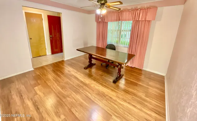 a living room with furniture and a painting on the wall