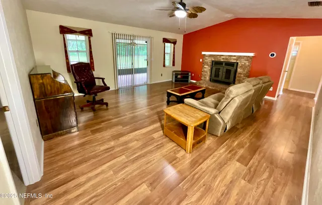 a living room with furniture a fireplace and a flat screen tv