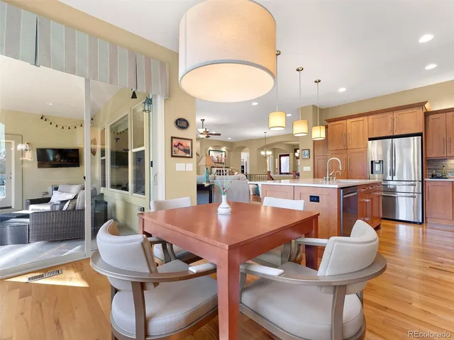 a dining room with furniture a table and kitchen view