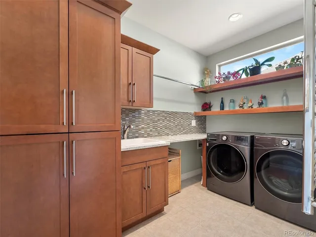 a utility room with sink dryer and washer
