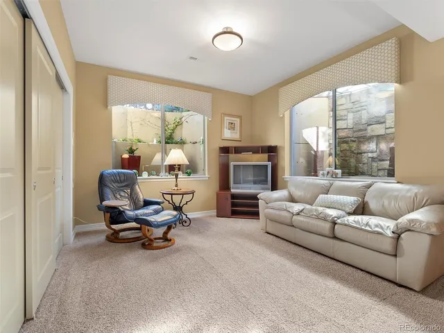 a living room with furniture fireplace and a large window