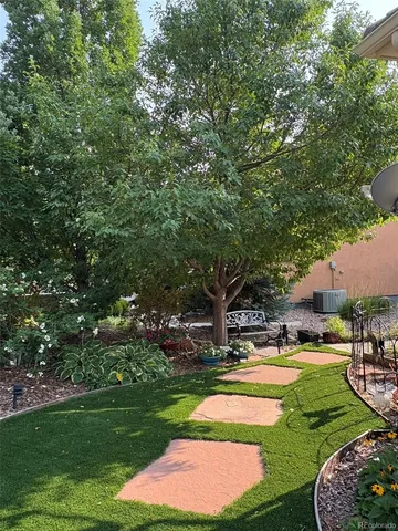 a view of a garden with cars