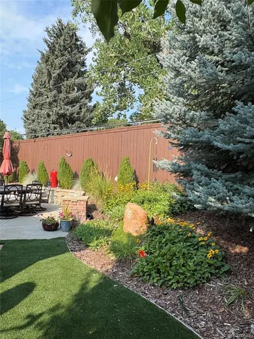 a view of a patio with a table chairs and a fire pit