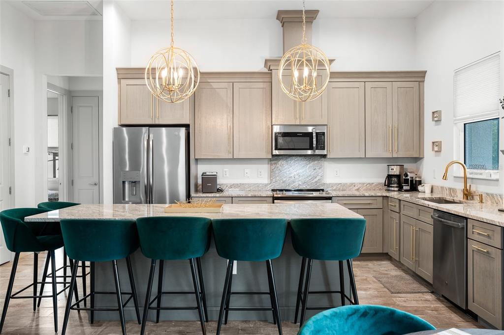 4528 Libby Road North Port, FL 34287 - Photo 14 of 43 a kitchen with stainless steel appliances a table chairs stove and cabinets
