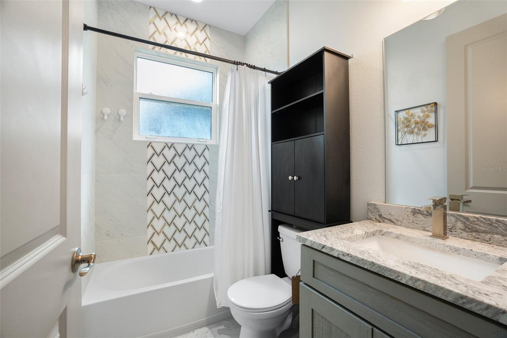 4528 Libby Road North Port, FL 34287 - Photo 30 of 43 a bathroom with a granite countertop sink toilet and shower