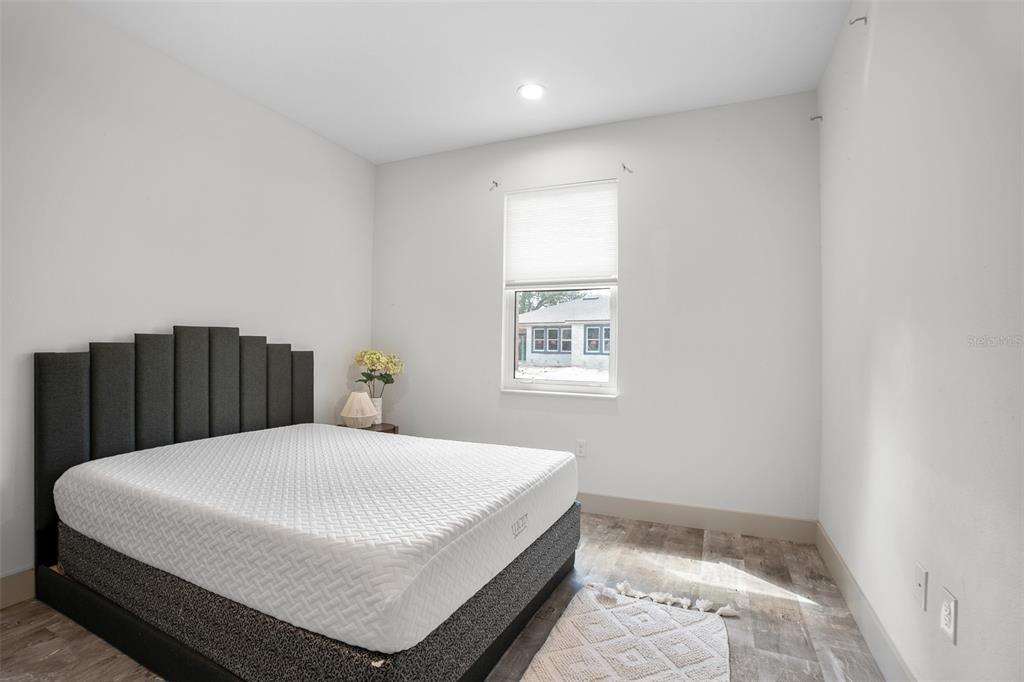 4528 Libby Road North Port, FL 34287 - Photo 32 of 43 a large bed sitting in a bedroom next to a window