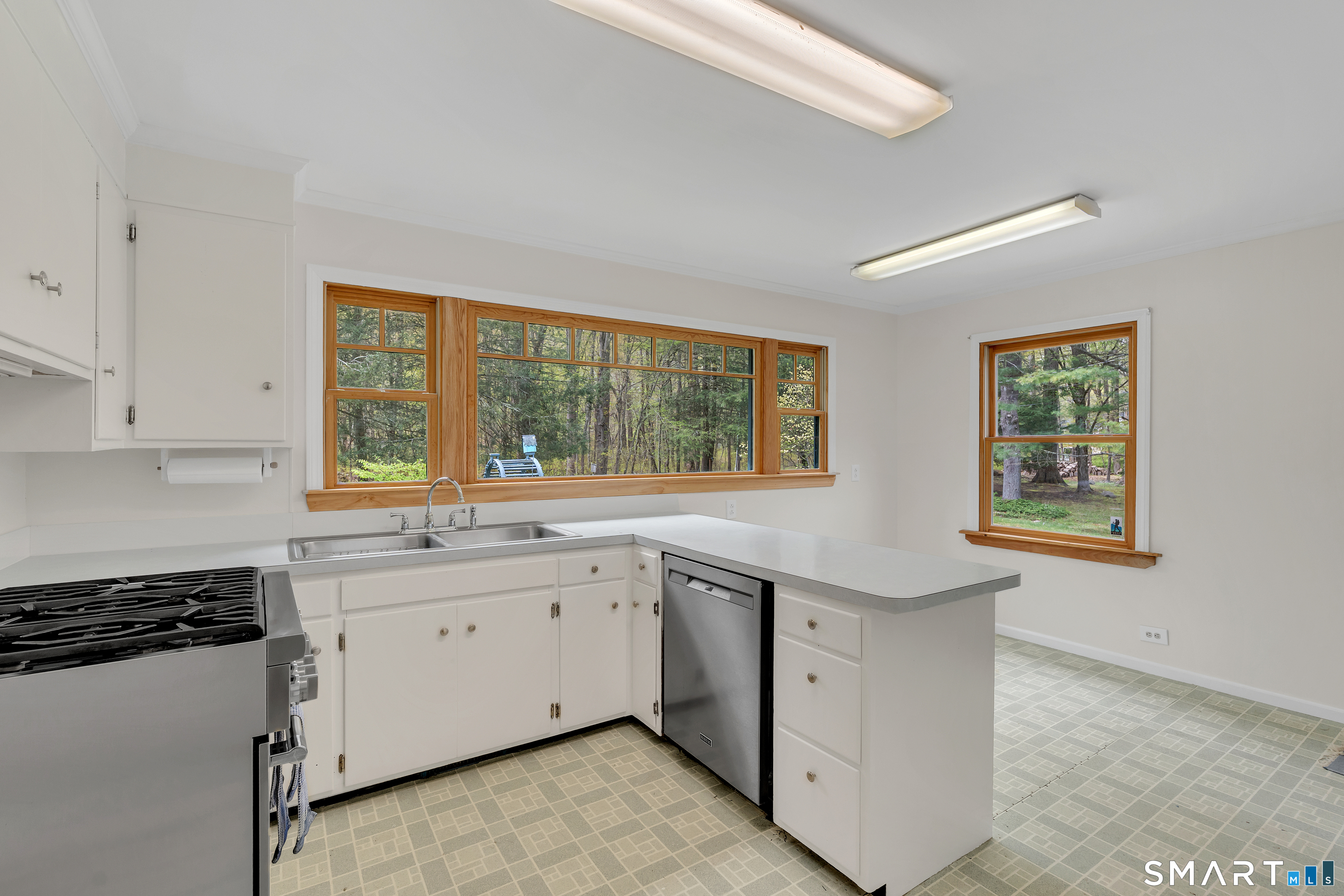 148 Old Redding Road Redding, CT 06896 - Photo 15 of 39 a kitchen with white cabinets and window