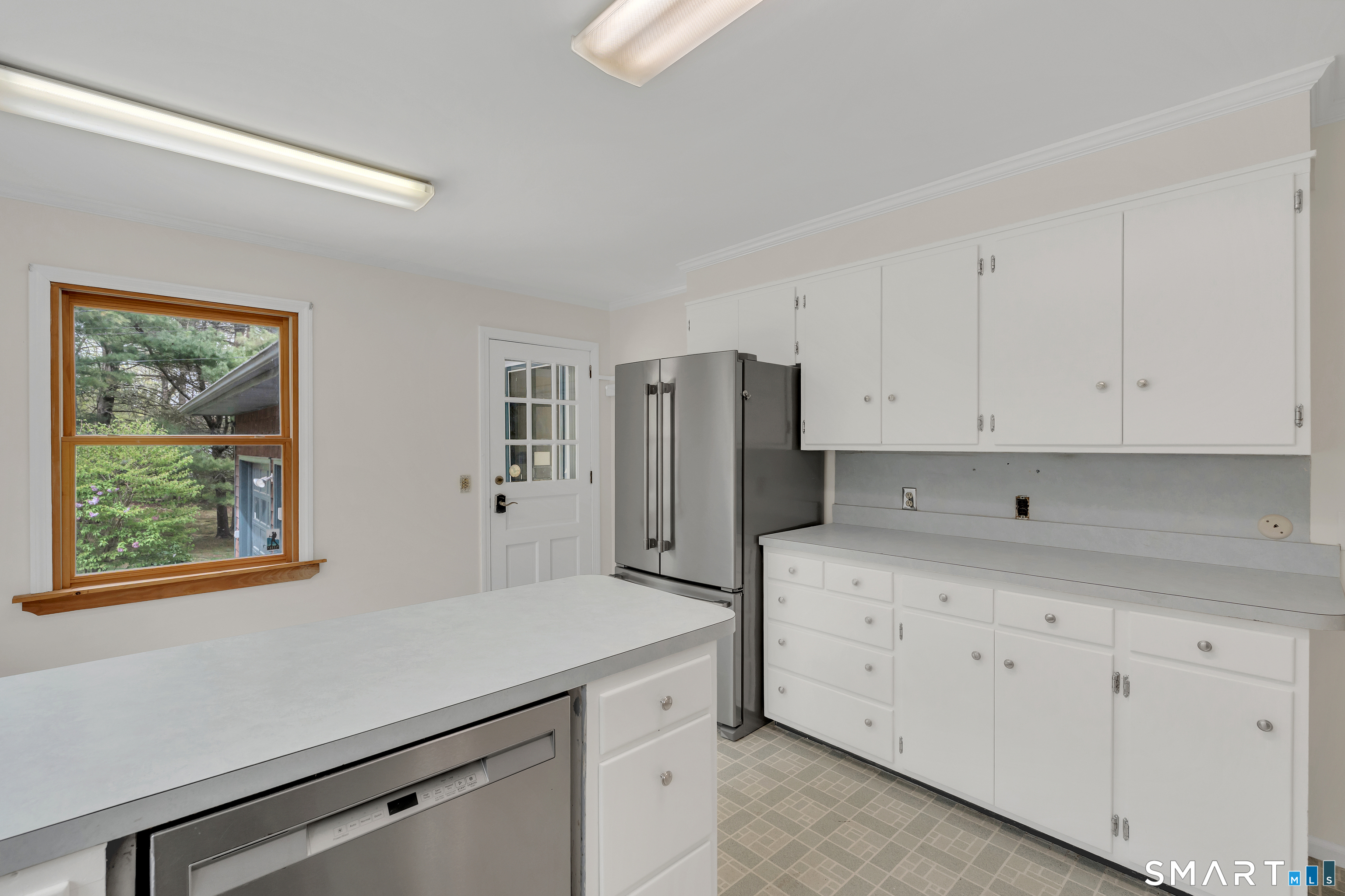 148 Old Redding Road Redding, CT 06896 - Photo 16 of 39 a kitchen with white cabinets and window