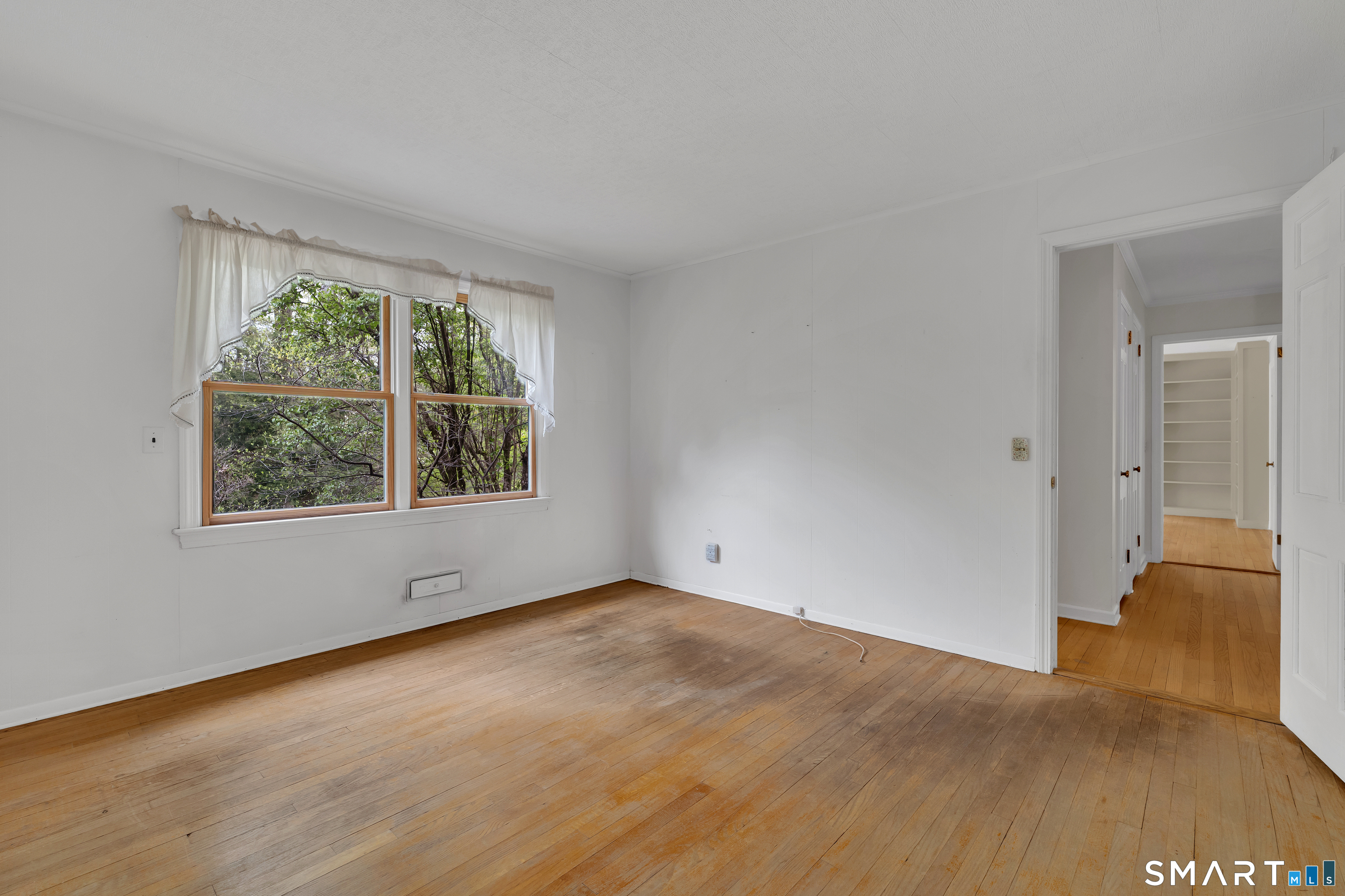 148 Old Redding Road Redding, CT 06896 - Photo 18 of 39 a view of an empty room with wooden floor and a window