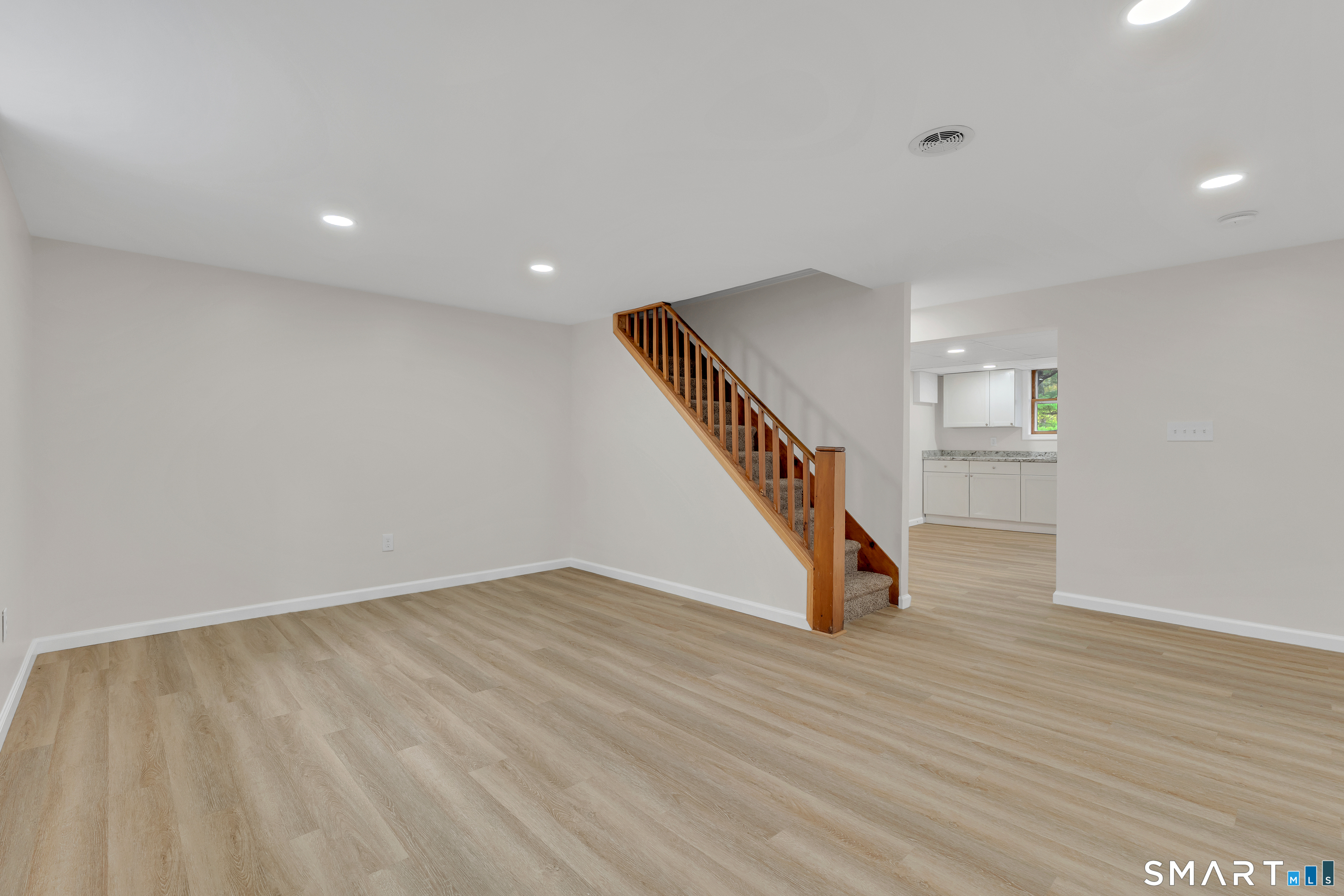 148 Old Redding Road Redding, CT 06896 - Photo 29 of 39 a view of an empty room with wooden floor and stairs