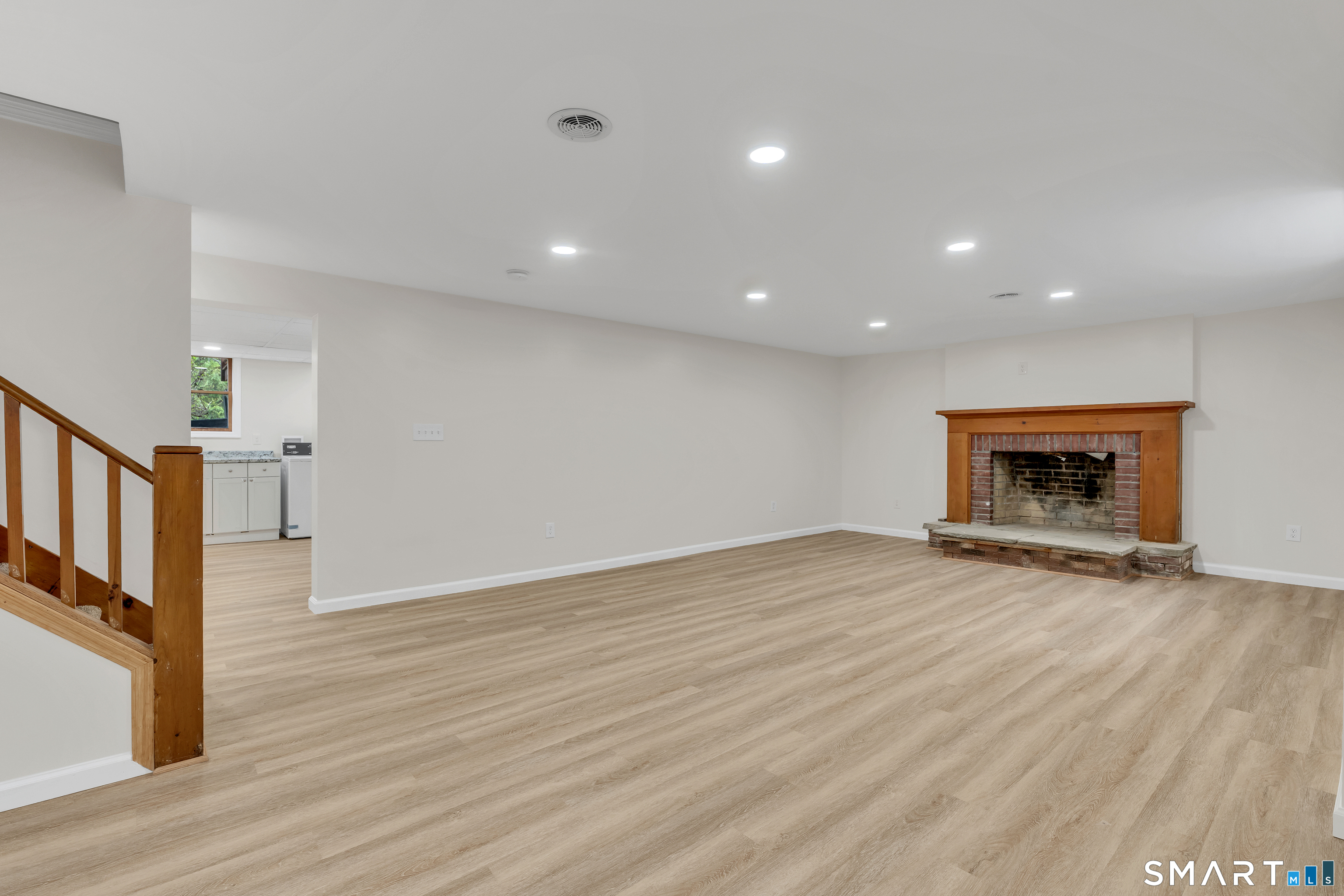 148 Old Redding Road Redding, CT 06896 - Photo 30 of 39 a view of an empty room with wooden floor fireplace and a window