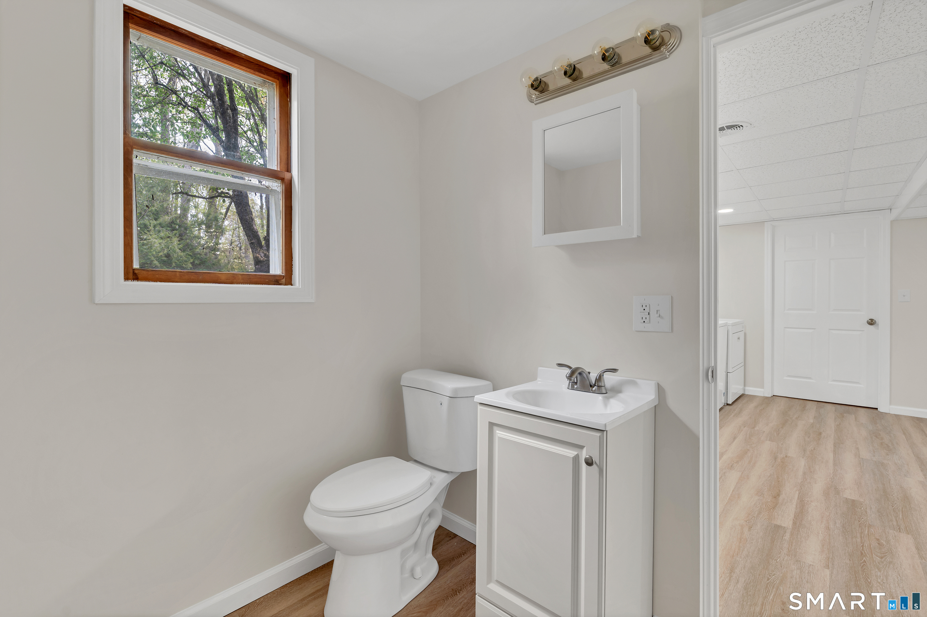 148 Old Redding Road Redding, CT 06896 - Photo 35 of 39 a bathroom with a sink toilet and window