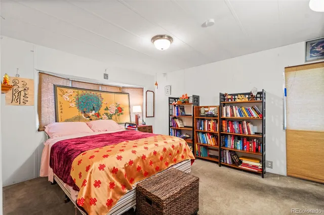 a view of a bedroom with a bed and a window