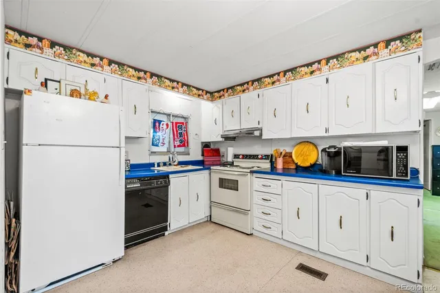 a kitchen with stainless steel appliances and white cabinets