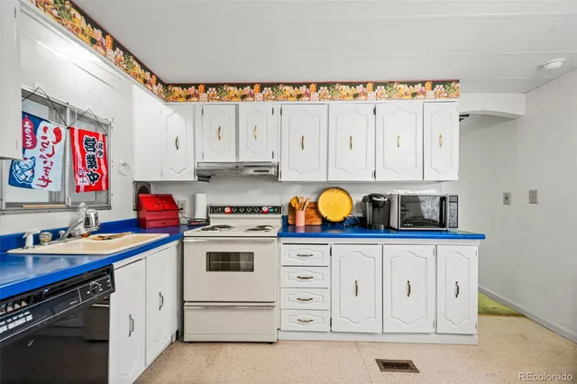 a kitchen with stainless steel appliances a stove a sink and a refrigerator