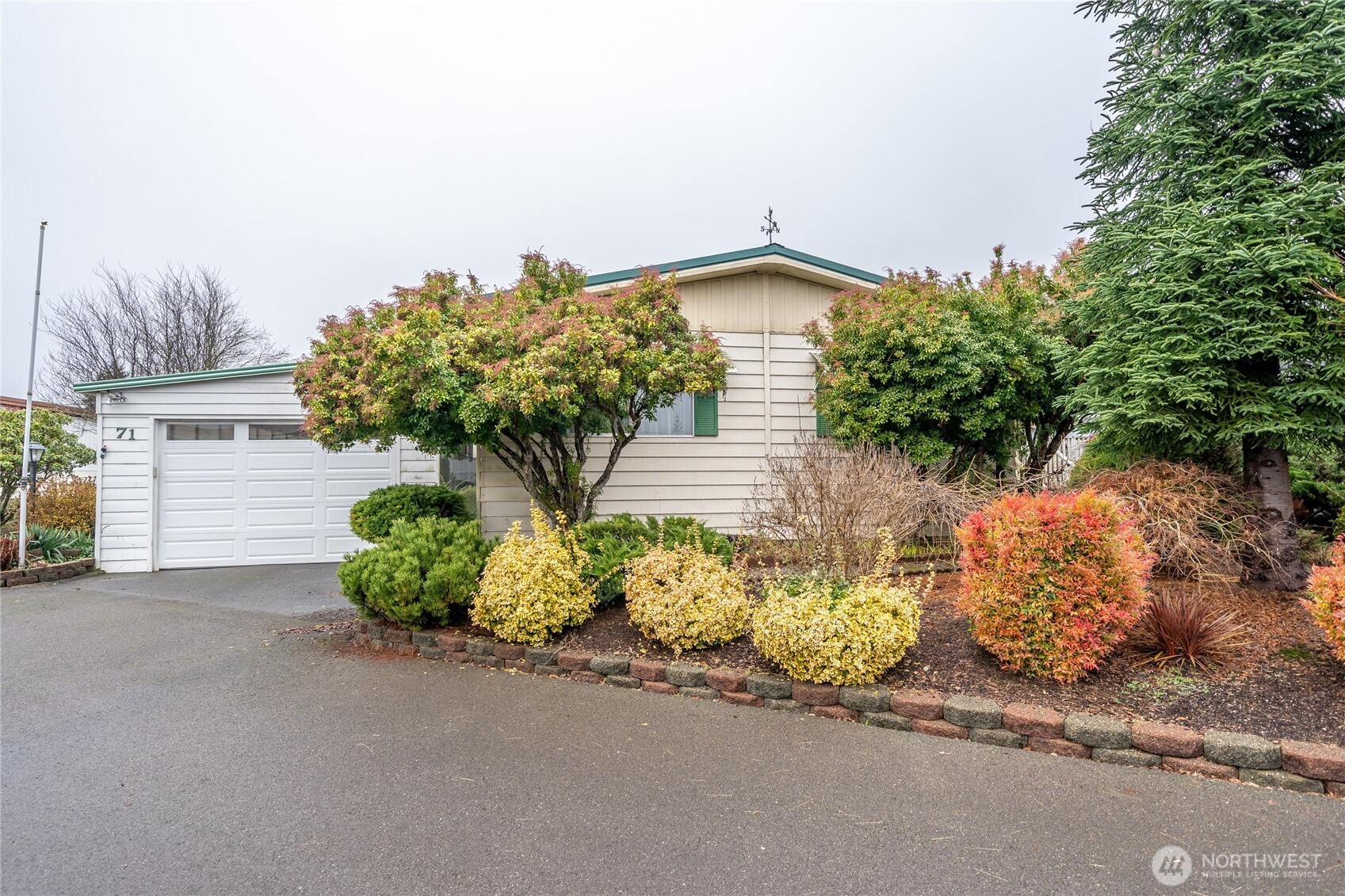 57 Clemons Road, Unit 71 Montesano, WA 98563 - Photo 1 of 26 a front view of a house with a yard and outdoor seating
