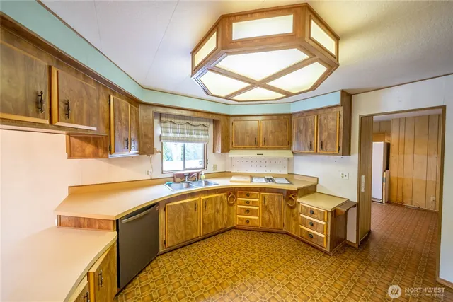 a large kitchen with a large window and a sink