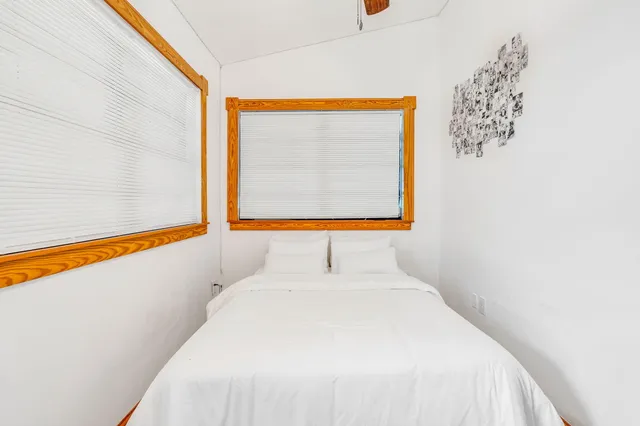 a bedroom with a bed and a painting on the wall