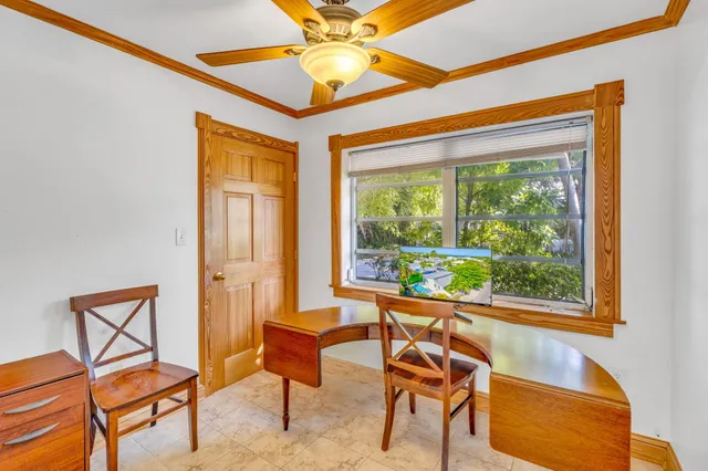 a dining room with furniture and a window