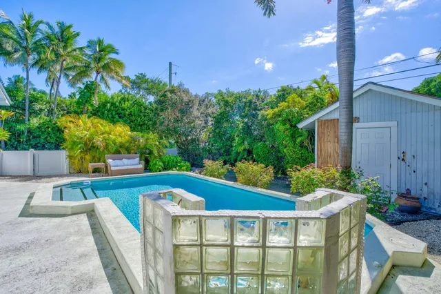 a view of a backyard with plants and a patio