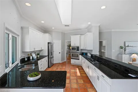 a kitchen with refrigerator and stove