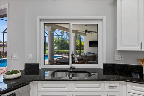 a kitchen with a sink and large window