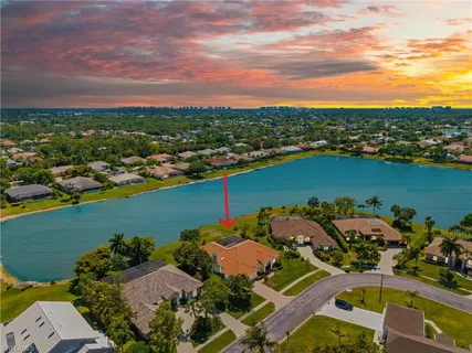 an aerial view of a houses with a lake view
